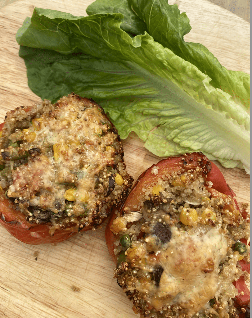 Peppers stuffed wtih quinoa and vegetables topped with cheese