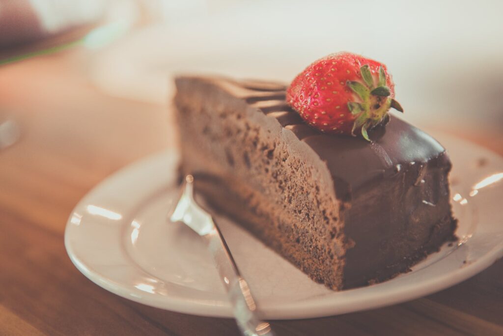 sliced chocolate cake on ceramic saucer